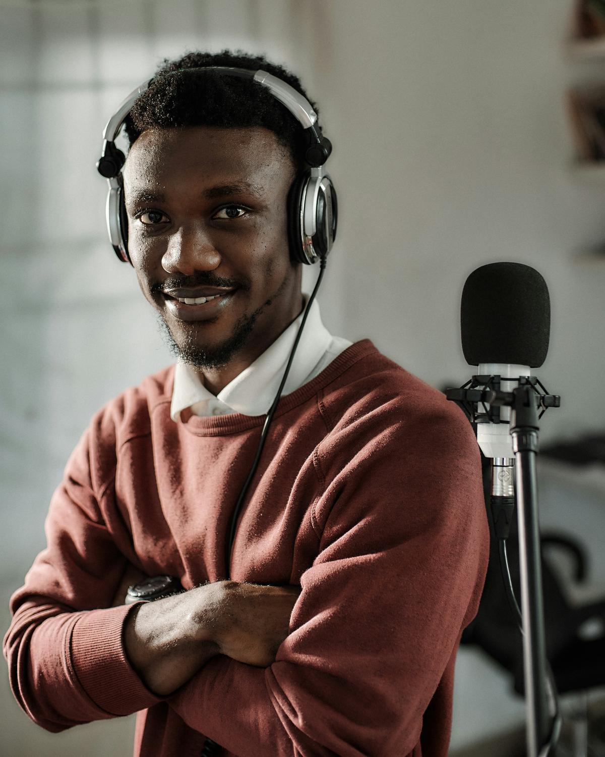 An image showing a person wearing headphones while recording a podcast, representing the concept of direct monetization models for podcasts in 2024.