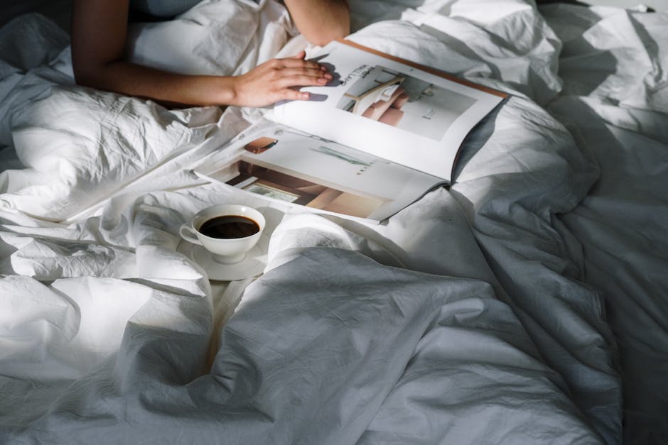 Image of a person reading an eBook on a tablet with a cup of coffee in the background.