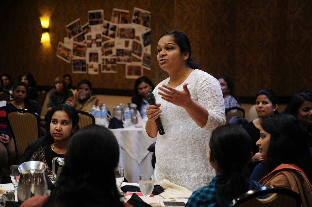 A group of people sitting around a table, participating in a focus group discussion.