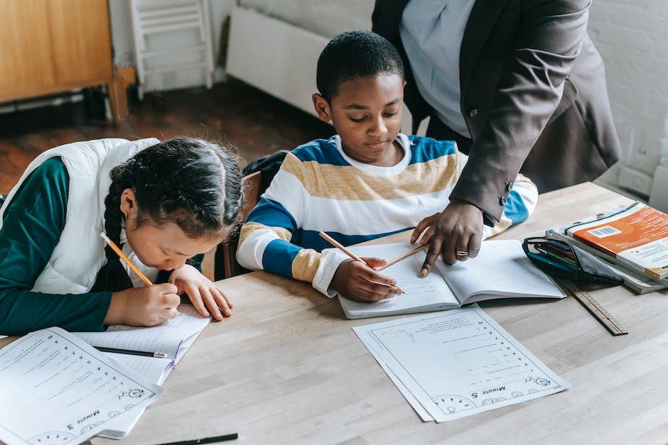 Image of a diverse group of students in a classroom, engaged in learning with a tutor.