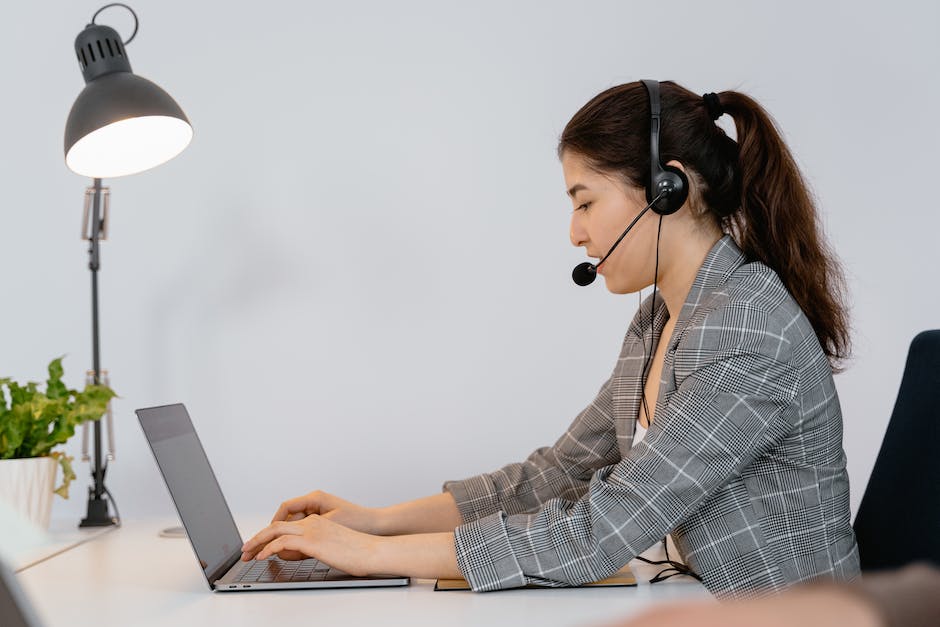 A person typing on a keyboard with a headset on, representing transcription jobs.